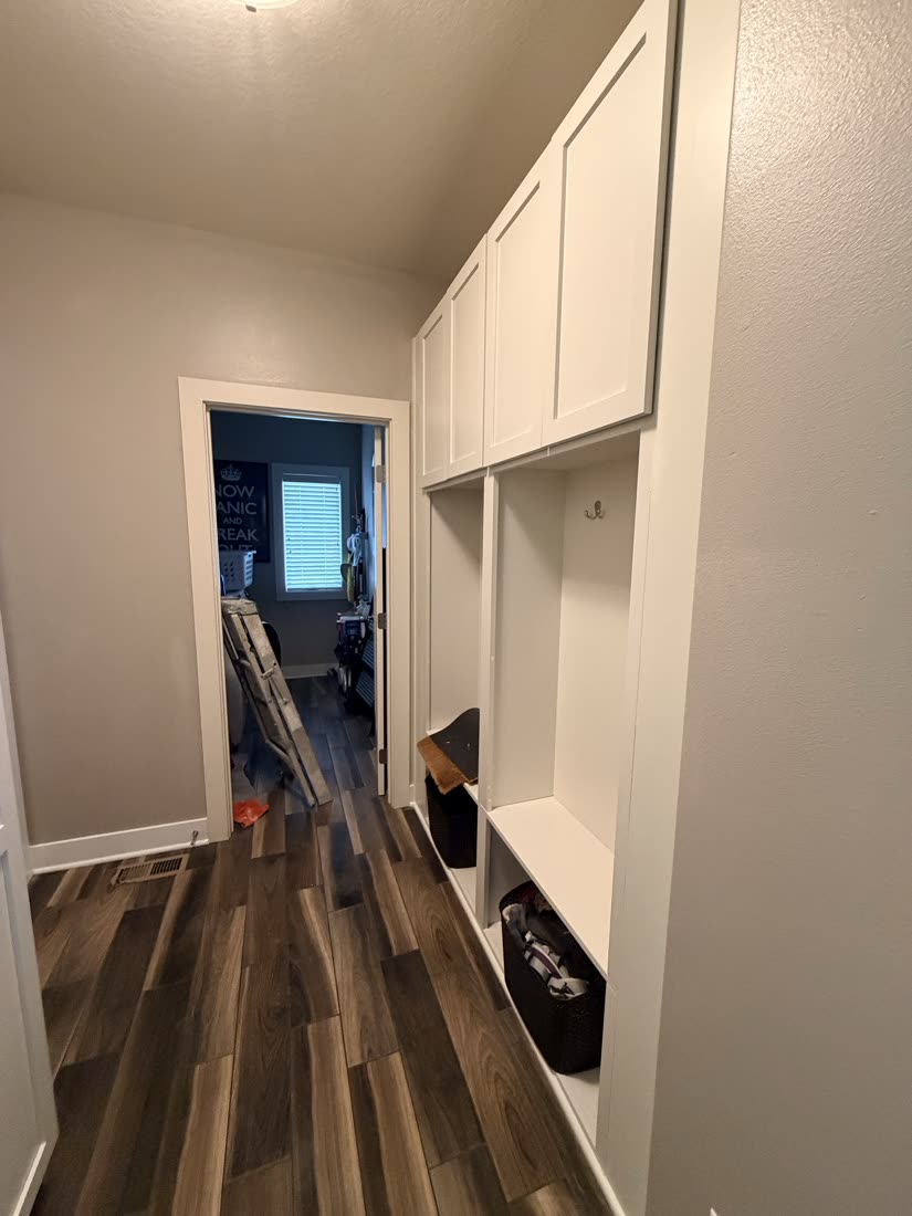 Hallway with built-in storage and light painted walls