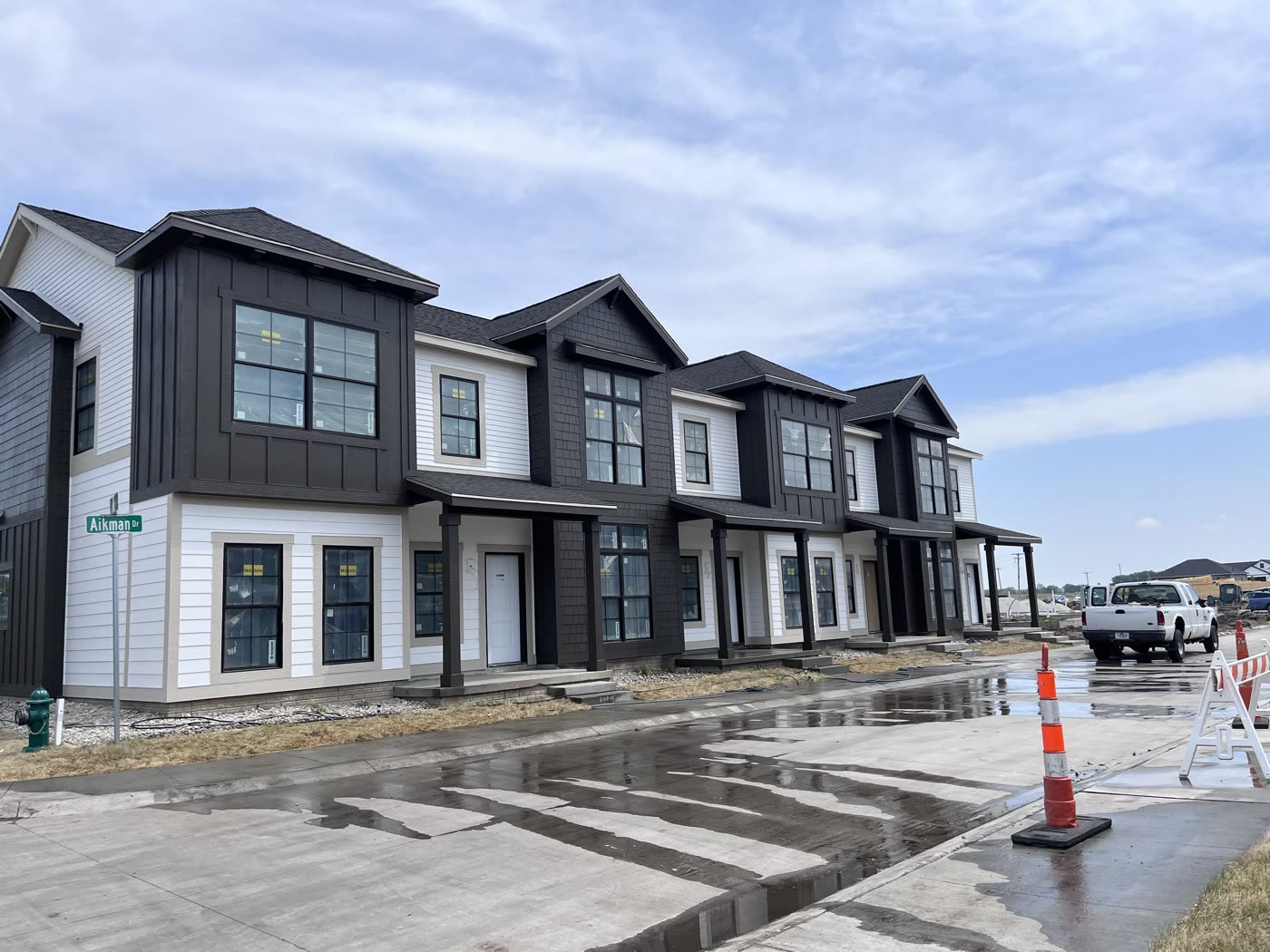 Row of new multi-unit buildings with dark and white siding