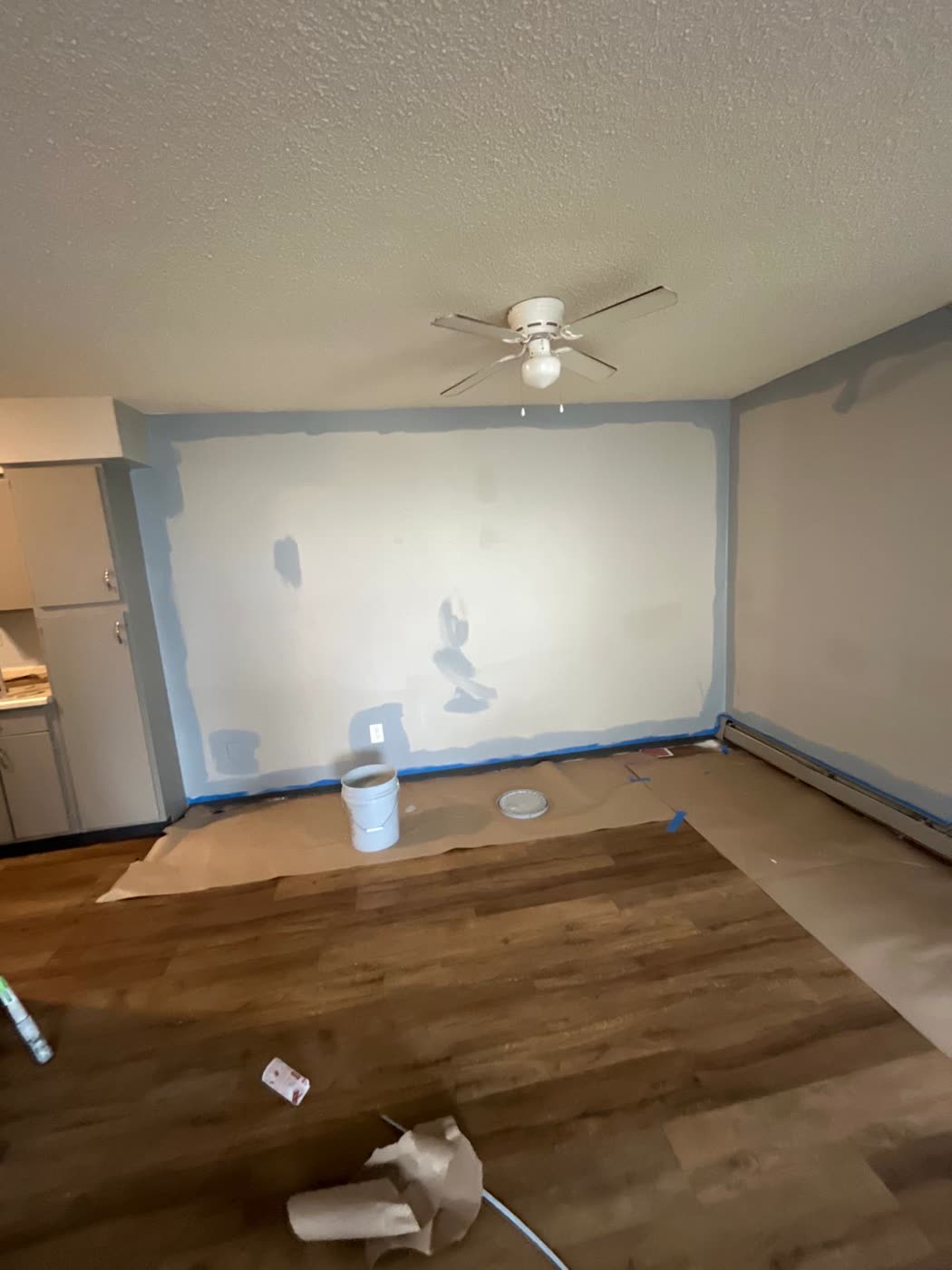 Room with masked walls and covered floors ready for painting
